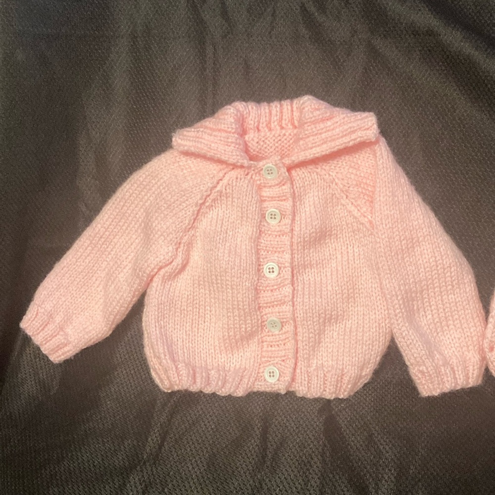 New hand knitted baby sweater and hat.